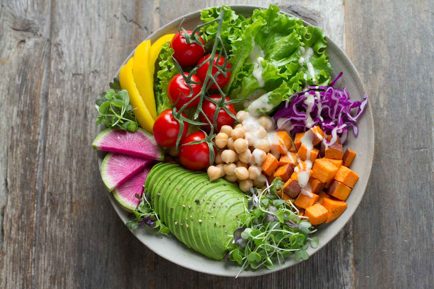 Colorful plate with salad, vegetables and fresh produce